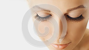 Beautiful girl with long false eyelashes and perfect skin. Eyelash extensions, cosmetology, beauty and skin care