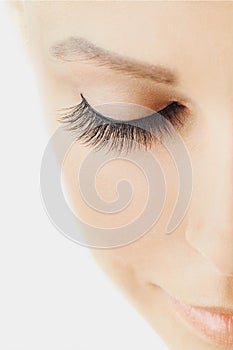 Beautiful girl with long false eyelashes and perfect skin. Eyelash extensions, cosmetology, beauty and skin care