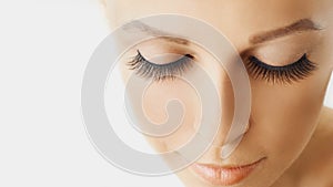 Beautiful girl with long false eyelashes and perfect skin. Eyelash extensions, cosmetology, beauty and skin care photo