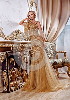 Beautiful girl in a long gold dress
