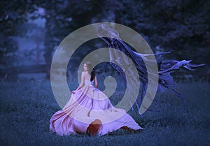 Beautiful girl in a long, pink, fluttering dress runs away from death in the form of a dark demon who came out of hell