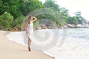 Beautiful girl looking far away being on the seacoast in Thailand