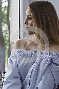 Beautiful girl looking out the window