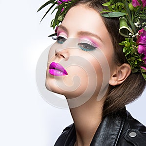 Beautiful girl with a lot of flowers in their hair and bright pink make-up. Spring image. Beauty face.