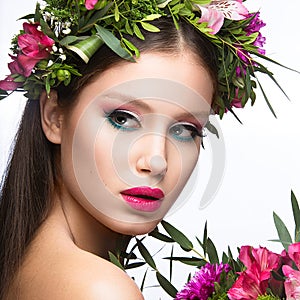 Beautiful girl with a lot of flowers in their hair and bright pink make-up. Spring image. Beauty face.