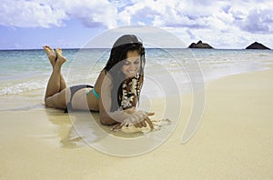 Beautiful girl lounging on the sand