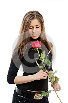 Beautiful girl in love holding a red rose