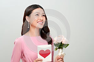 Beautiful girl with love letter and flowers. Happy woman day.