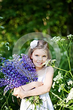 Beautiful girl with lupines