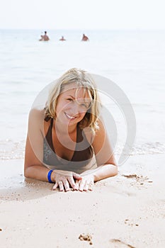 Beautiful girl lying on the beach