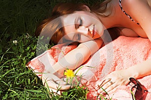 Beautiful girl lying down of grass