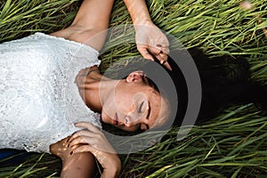 Beautiful girl lying down at grass