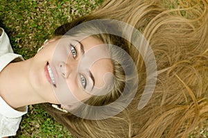 Beautiful girl lying down of grass