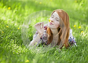 Beautiful girl lying down at grass.