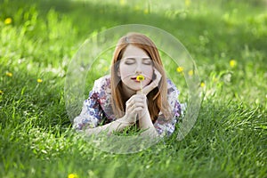 Beautiful girl lying down at grass.