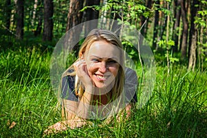 Beautiful girl lying down on grass