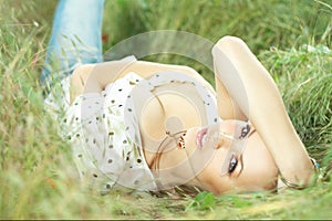 Beautiful girl lying down of grass