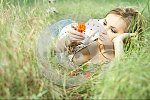 Beautiful girl lying down of grass