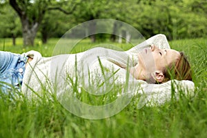 Beautiful girl lying down of grass