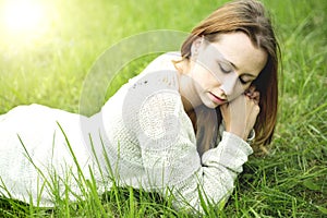Beautiful girl lying down of grass