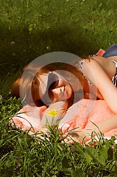 Beautiful girl lying down of grass