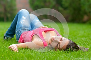 Beautiful girl lying in the grass