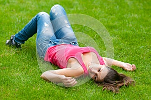 Beautiful girl lying on the grass