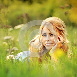 Beautiful girl lying in grass