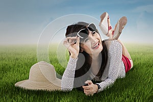 Beautiful girl lying on the grass