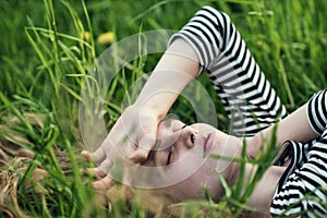 Beautiful girl lying on the grass dreaming