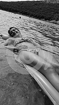 Beautiful Girl lying on a mattress in Water