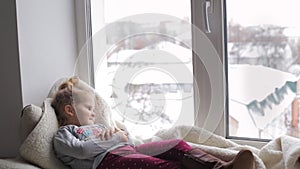 Beautiful girl lying on a window sill