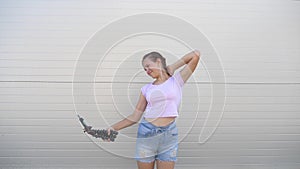 Beautiful girl makes selfie outdoors. teenager is photographed on a smartphone using small tripod. young girl blogger