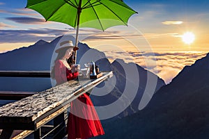 Beautiful girl making drip coffee at sunrise viewpoint in Pha Hi village, Chiang Rai Province, Thailand