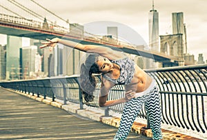 Beautiful girl making stretching before intense running in New york city