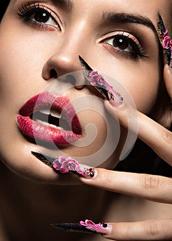 Beautiful girl in mask with long nails and sensual lips. Beauty face.