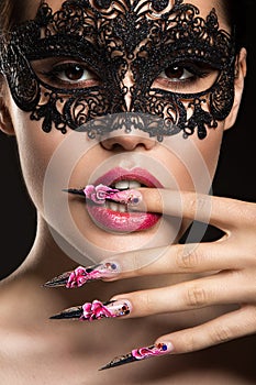 Beautiful girl in mask with long nails and sensual