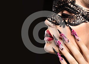 Beautiful girl in mask with long nails and sensual photo