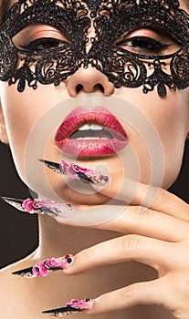 Beautiful girl in mask with long nails and sensual