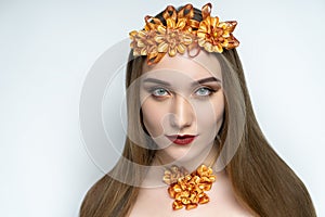 Beautiful girl, massive gold accessory necklace, matte vine lipstick