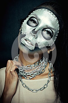 Beautiful girl model with black body with silver mask