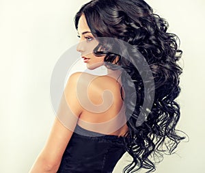 Beautiful girl model with long black curled hair