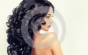 Beautiful girl model with long black curled hair
