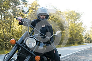 Beautiful girl on a motorcycle in the sun