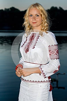 Beautiful girl in national Ukrainian embroidery shirt and wreat