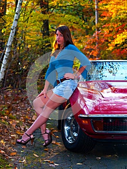 Beautiful Girl next to Corvette in Fall