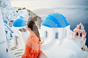 Beautiful girl in Oia village on Santorini island