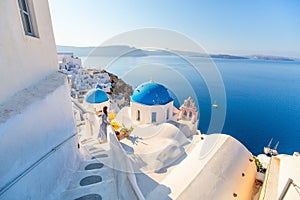 Beautiful girl in Oia village on Santorini island