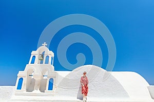 Beautiful girl in Oia village on Santorini island