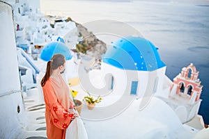 Beautiful girl in Oia village on Santorini island